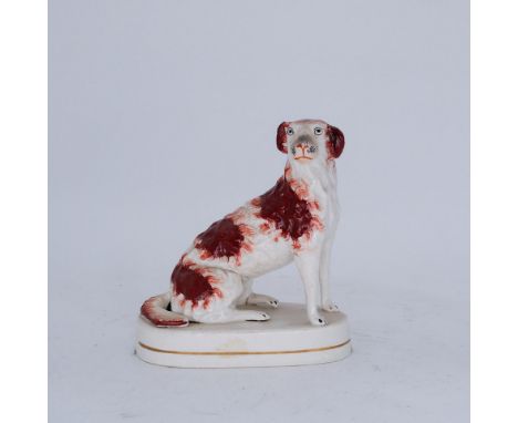 DOGS: A Staffordshire Pottery Figure of a Hunting Dog, modelled as a Setter, mid 19th century,  seated with russet red spots 
