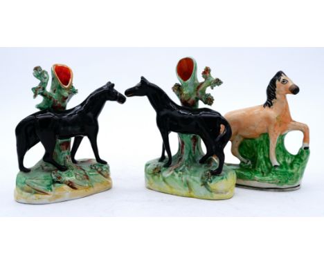 HORSES: A pair of Staffordshire Pottery Spill Vases, modelled with black horses, mid 19th century,  each standing before a ho