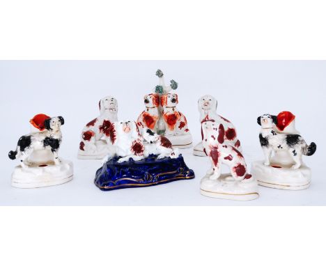 SPANIELS: Seven assorted small Staffordshire Spaniels, including a pair of quill stands or inkwells,  each with a spaniel sta