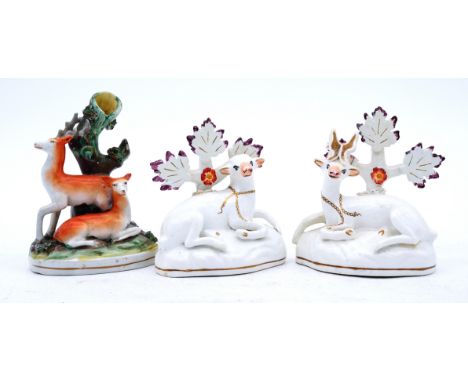 ANIMALS: Three assorted Staffordshire Figures of Deer, including a pair of a Roe Buck and Doe,  both recumbent in front of wh