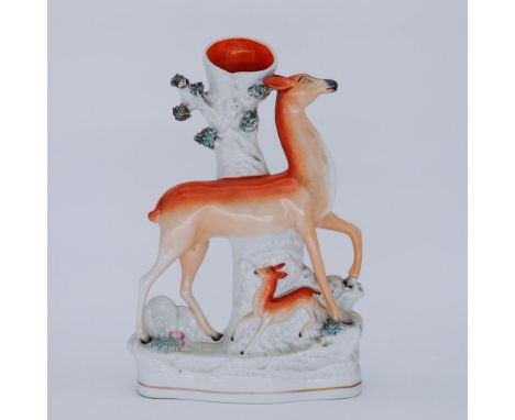 ANIMALS: A Staffordshire Pottery Flatback Spill Vase, modelled as a Deer and Faun, mid 19th century,  the doe striding right,