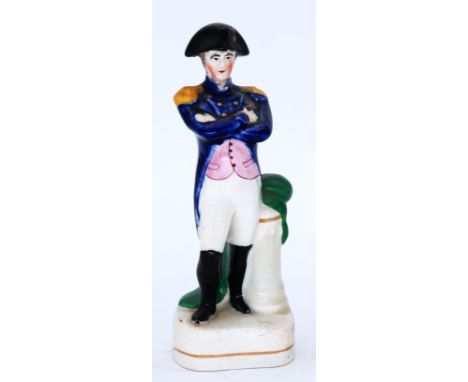 MILITARY: A rare Staffordshire Pottery Portrait Figure, modelled as Napoleon Bonaparte, circa 1840,  standing in uniform with