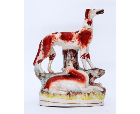 DOGS: A rare Staffordshire Pottery Flatback Figure, modelled as a Saluki over a Deer, 19th century,  standing on point, facin