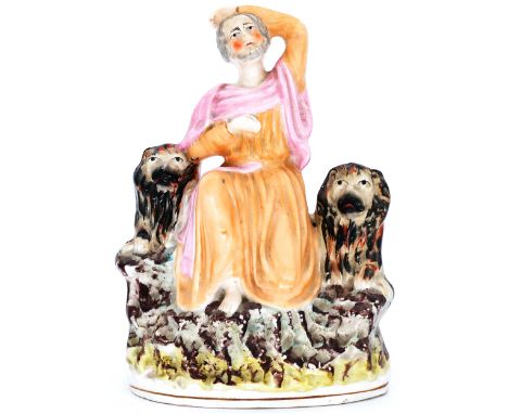 HISTORICAL: A Staffordshire Pottery Portrait Figure, modelled as Daniel in the Lion's Den, mid 19th century,  he seated in ro