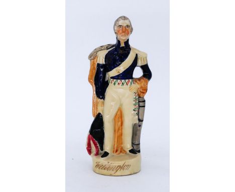 MILITARY: A Staffordshire Pottery Portrait Figure, modelled as The Duke of Wellington, circa 1850,  standing in uniform and h