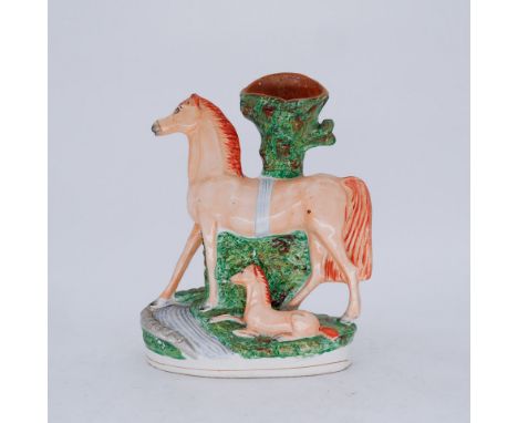 ANIMALS: A Staffordshire Pottery Spill Vase Group, of a Horse and Foal, mid 19th century,  standing before a hollow trunk, a 