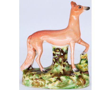 DOGS: A Staffordshire Pottery Flatback, modelled as a Red Fox, or hunting dog, mid 19th century,  standing facing right with 