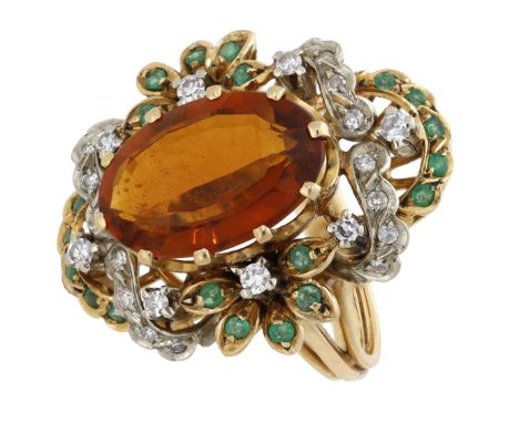 A gem-set dress ring, the oval-shaped citrine within an openwork foliate surround set throughout with circular-cut emeralds a