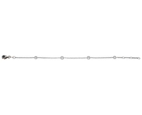 A diamond bracelet, spectacle-set with brilliant-cut diamonds spaced by a fine cable-link chain, stamped ‘K18 750’, total dia