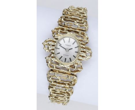 Tissot. A lady’s gold bracelet watch, Stylist, circa 1970. Movement: manual winding. Dial: silvered, applied baton indexes. C