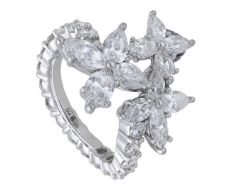 A diamond dress ring, of crossover design, the flowerhead terminals set with marquise and pear-shaped diamonds, the hoop set 