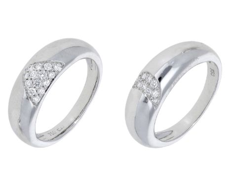 A pair of diamond rings, of bombé design, each set with a wave of brilliant-cut diamonds to the front, stamped ‘750’, ring si