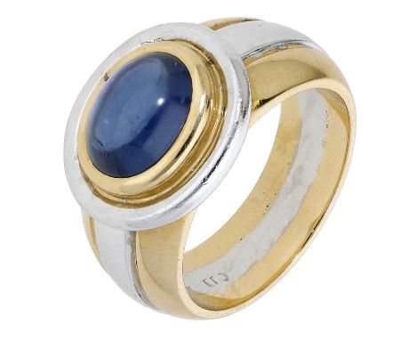 A sapphire dress ring, the oval sapphire cabochon in a bicoloured mount of reeded design, stamped ‘750’, ring size L. £400-£6