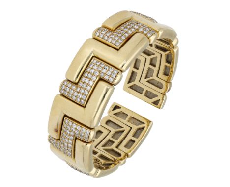 A diamond cuff, formed of stepped panels alternately set with brilliant-cut diamonds, stamped ‘750’, total diamond weight app