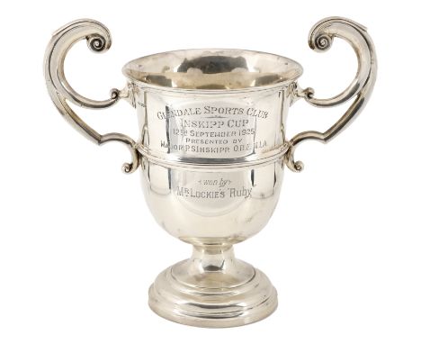 A George V silver trophy cup, with ‘C’-scroll handle and girdled body, the Glendale Sports Club (Inskipp Cup) presentation in