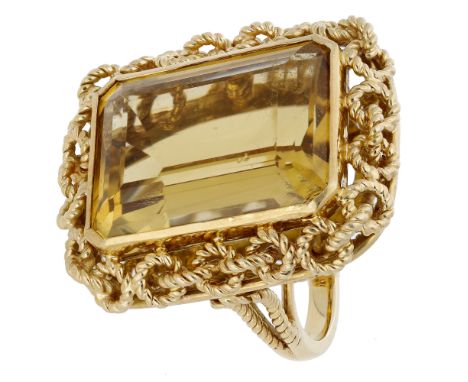 A citrine dress ring, the step-cut citrine collet-set within a pierced ropetwist surround, to bifurcated shoulders, partially