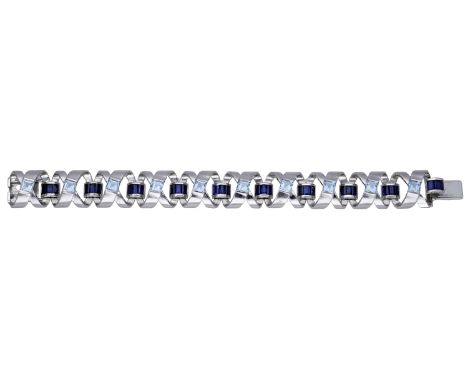 A sapphire and aquamarine bracelet by Boodles, 2000, the openwork spirals set with baguette-cut sapphires and square-cut aqua