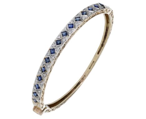 A sapphire and diamond bangle, the front set with a row of square-cut sapphires with single-cut diamond highlights between, t