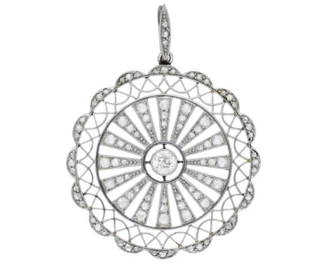 A diamond pendant, circa 1915, the pierced circular plaque with an old brilliant-cut diamond to the centre, the sunburst surr