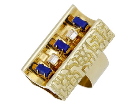 A lapis lazuli and diamond dress ring by Vendorafa, circa 1970, the abstract rectangular panel incorporating a concave channe