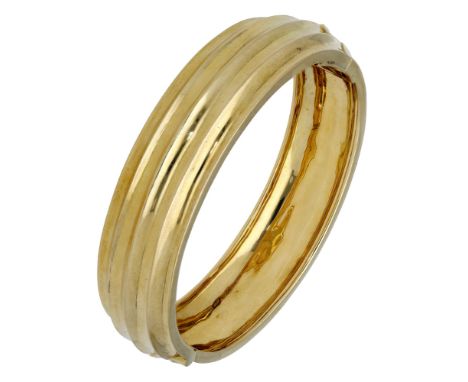 An 18ct gold bangle, of reeded design, London import mark for 1998, inner diameter 5.3cm. £1,500-£2,000  ---  Condition Repor