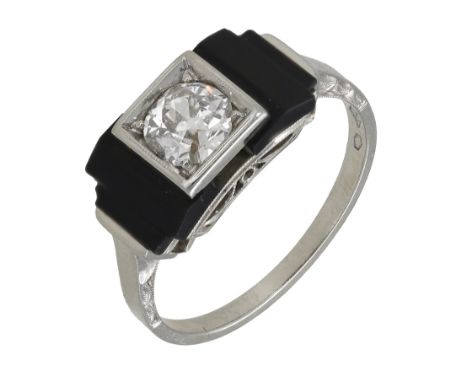 An Art Deco onyx and diamond ring, set with an old brilliant-cut diamond in square setting, between stepped onyx shoulders, m