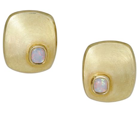 A pair of opal ear clips, each comprising a cushion-shaped panel collet-set with an opal cabochon, the gold mounts with brush