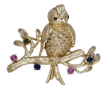 A gem-set novelty brooch, designed as a bird on a branch with circular-cut gemstone highlights to the foliage, stamped ‘14K’,