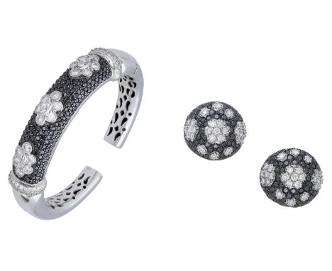 A diamond bangle and ear clip suite, the hinged cuff with three marquise and brilliant-cut diamond clusters to the bombé fron