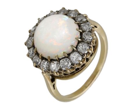 An opal and diamond cluster ring, the domed opal cabochon claw-set within a surround of old brilliant-cut diamonds, total dia