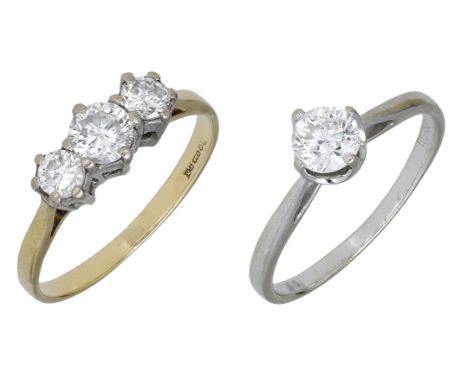 Two diamond rings, the first set with a brilliant-cut diamond, stamped ‘WG 750’, the second set with three brilliant-cut diam