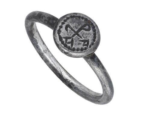 A late Byzantine 10th/11th century silver ring, the circular sectioned hoop and round bezel engraved with a merchant’s symbol