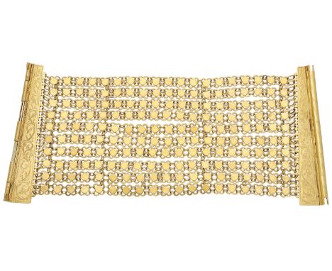 A gold bracelet, the multi-row chain bracelet with openwork quatrefoil links, the clasp with engraved scroll and foliate deco
