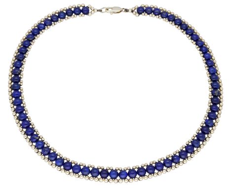 A lapis lazuli necklace, the uniform row of lapis lazuli beads within polished bead borders, stamped ‘14K’, length approximat