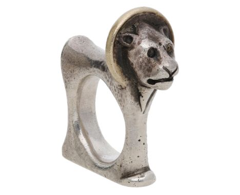 A silver lion ring by Mosheh Oved, circa 1945, of angular form with hammered finish, the mane modelled in gold, the shank for