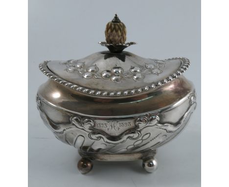 A Victorian silver caddy, of oval form, with carved ivory finial, embossed decoration, gadrooned border and engraved inscript