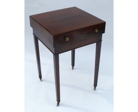 A late Georgian mahogany free standing lamp table, having an overhanging top and single drawer, raised on square tapered legs