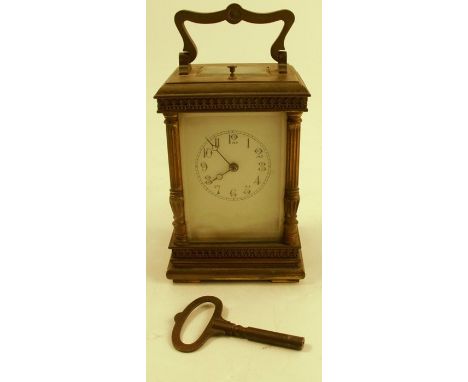 A brass cased repeating carriage clock, with white enamel dial, height including handle 7.25ins
