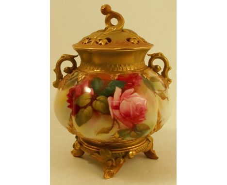 A Royal Worcester covered vase, the quarter lobed body decorated with roses, raised on four naturalistic moulded feet, with a