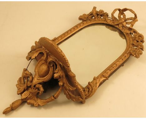 A 19th century gilt framed wall mirror, the curved top frame with leaf decoration, the top with ribbon bowl and flowers, with