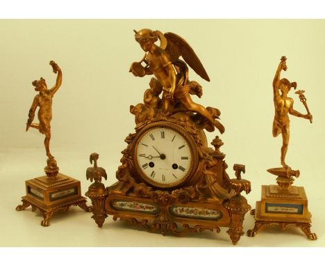 A 19th century gilt metal and porcelain clock garniture, the striking movement stamped Dent A Paris, the white enamel dial, w
