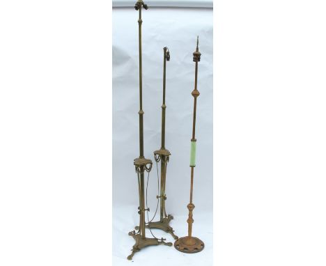 Two similar Regency design telescopic standard lamps, decorated with swags, terminating in claw feet, together with another s