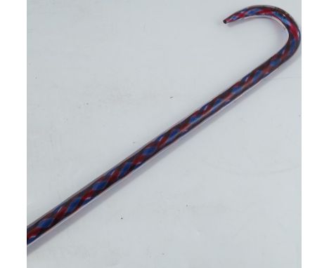 A Victorian glass walking stick, decorated with a red and blue spiral, height 39ins