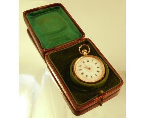 A fob watch, stamped '18k', the white enamel dial with black Arabic numerals, gilt hands and gilt detail border, the four pie