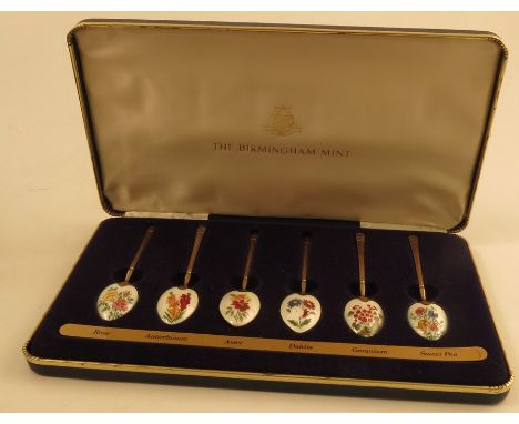 A boxed set of six silver gilt and enamel tea spoons, the backs of each bowl enamelled with a different flower, Birmingham 19