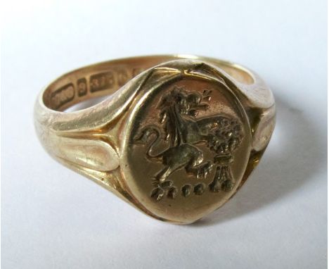 A 9 carat gold crested signet ring, finger size K, 4.4g grossCondition Report:  Good condition