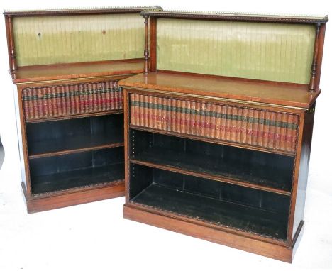 A pair of 19th century rosewood and amboyna bookcases, the superstructure having a pierced brass gallery to a shelf supported