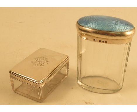 Two glass and silver mounted dressing table jars, the one of rectangular form and engraved with initials, London 1869 and the