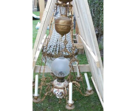 A pottery and brass oil lamp chandelier light fitting, the pottery lamp base with frosted glass shade, having gilt metal moun