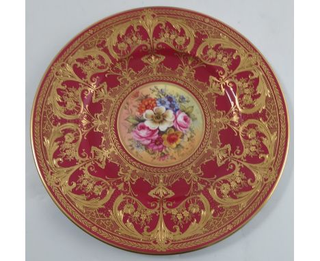 A Royal Worcester cabinet plate, the centre painted with flowers by Freeman, with gilt decoration to the burgundy border, dat